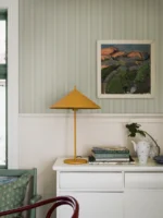 Et lyst og moderne interiør med Sam-tapet fra Boråstapeter på veggene. De subtile stripene skaper en harmonisk bakgrunn som på avstand kan fremstå som en ensfarget flate med dybde