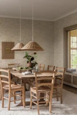 Et lyst og trivelig rom med Boråstapeter Isidor på veggen, som tilfører en tidløs og botanisk stil til interiøret.