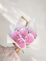 En fyldig bukett med kunstige, rosa peoner
